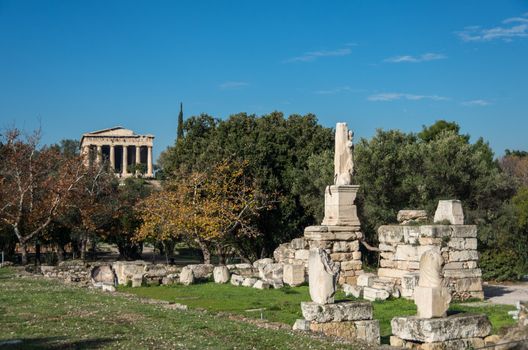 Odeon of Agrippa statues with Temple of Hephaestus at background. Ancient Agora of Athens, Greece