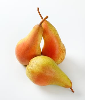 three ripe pears on white background