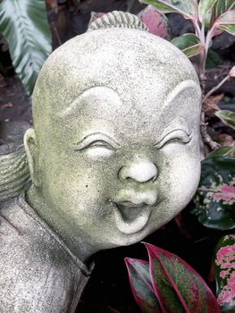 Statue of an old smiling boy