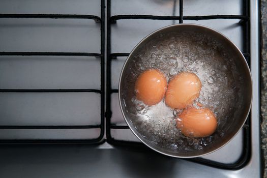 eggs in boiling water on stove