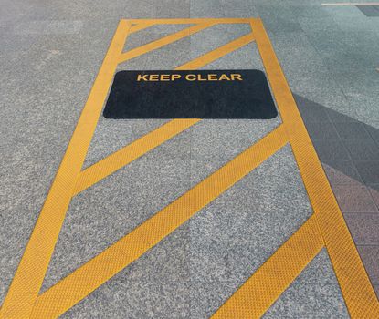 Keep clear sign on floor at the station before take in sky train, Bangkok, Thailand.