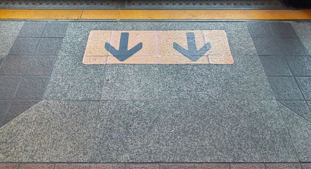 Yellow arrow direction points to exit of door sky train.