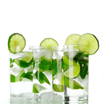 Party mojito cocktails with lime and mint isolated on white background