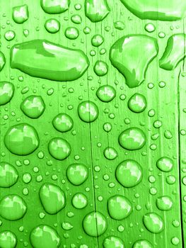 rain drops on on Green wooden bench