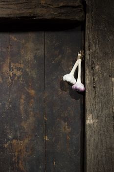 Bunch of garlic on an old wooden door