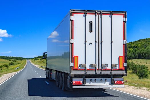 Picture of big truck with the trailer moves on the highway