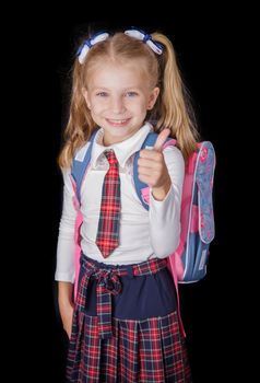 Joyful girl schoolgirl in blouse and skirt with  bag isolated on black background