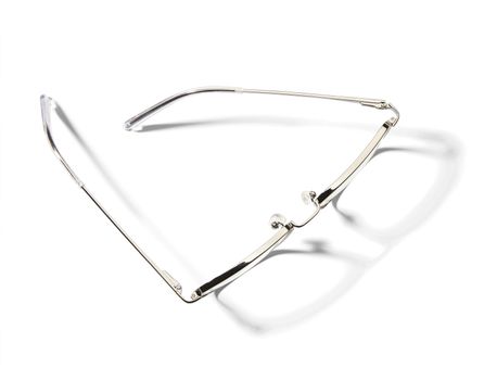  High angle view of pair of eyeglasses on white background with shadow.