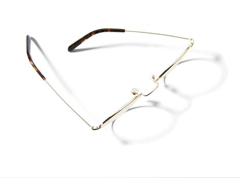 Studio shot of pair of eyeglasses on white background with shadow. 