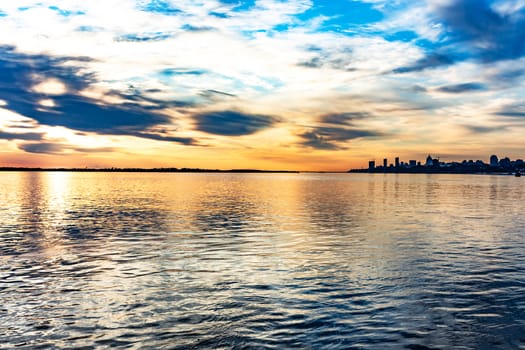 The sun went over the horizon of the Amur river in the city of Khabarovsk, forming magnificent colors in the sky. Beautiful colors in the sky, which are reflected in the water.