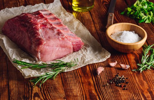 Raw Pork Loin with Ribs and Some Ingredients for Roasting