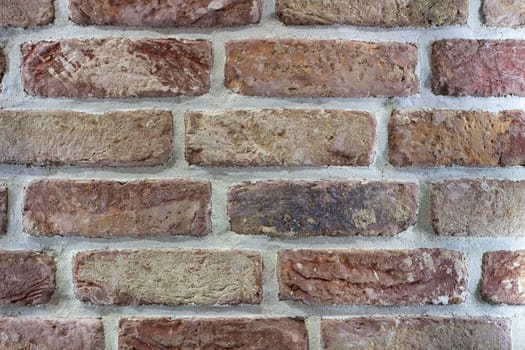 Natural wallpaper background pattern of red yellow brown gray wall bricks