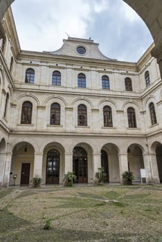 Sassari,Italy,12-april-2018:people are at the entrance of the Palazzo Ducale in Sassari on the italian island of sardegna, this is used as townhall, sassari is one of the biggest cities of sardinia