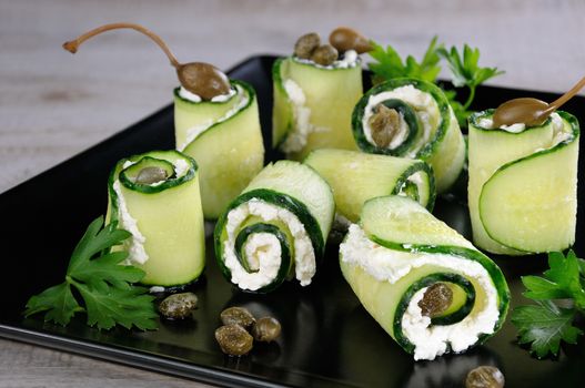 Cucumber rolls with ricotta filling and capers.   These rolls with the size of a bite -is a great option with a low fat content, which serves as a snack.