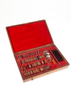 Old optometric set of lenses on isolated studio background