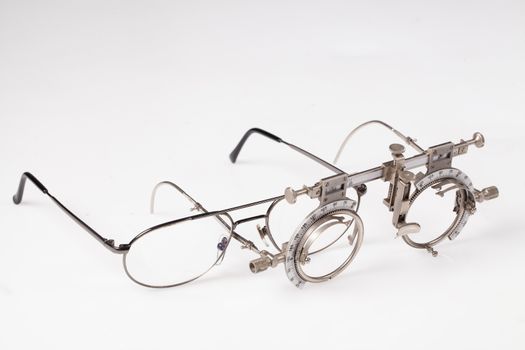 Old optometric device to choose the correct lense on isolated background