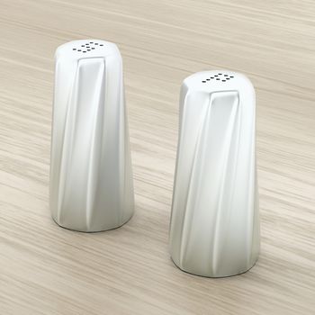 Metal salt and pepper shakers on wood background  