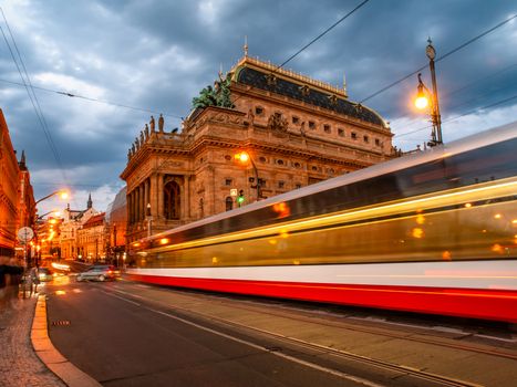 Evening at National Theater and blurred tram on the bridge, Prague, Czech Republic. Long exposure shot.