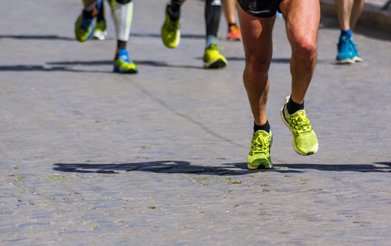City Marathon running race. Shoes on cobblestone street