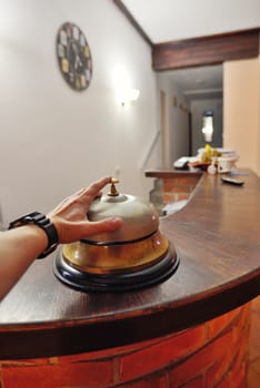 Hand ringing in service bell at hotel