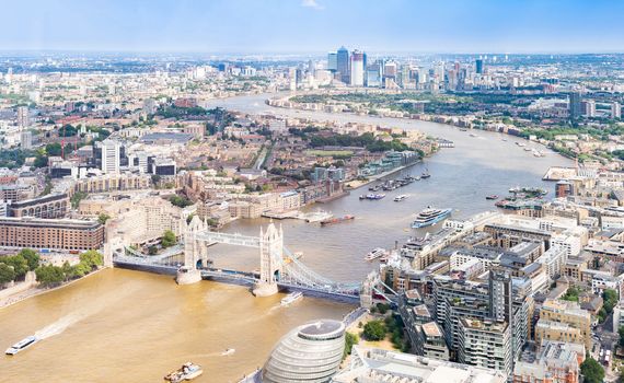 Aerial view of London Tower Bridge and Skyscraper in Canary Whraf, London UK.