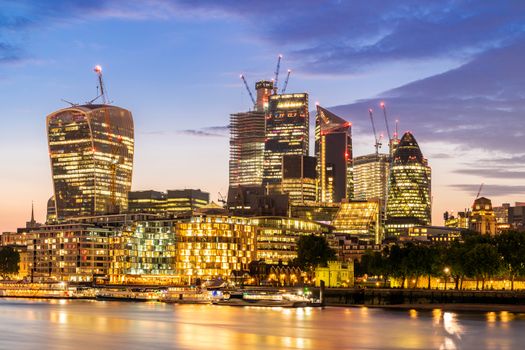 London downtown cityscape skylines building with River Thames at sunset dusk in London UK