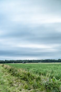 Barns in Farmfield with a cloudy sky.