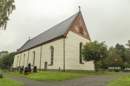 Church at Backen, Umea, Sweden with a cloudy sky.