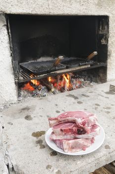 Raw steaks fiorentina-style, typical of Tuscany, Italy, ready to be cooked in a wood burning oven