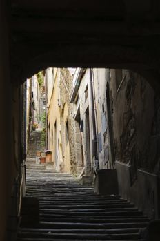 Narrow cobblestone alley and steep stairs in the historic centre of Cortona, Tuscany, Italy, Europe