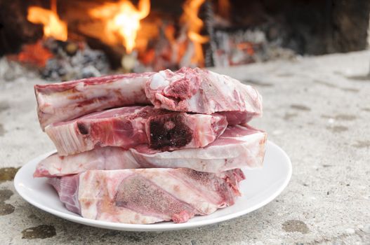 Raw steaks fiorentina-style, typical of Tuscany, Italy, ready to be cooked in a wood burning oven