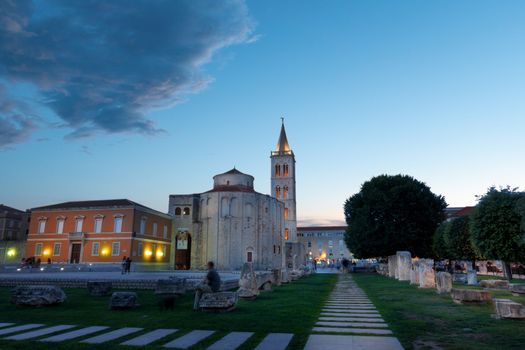 Zadar, Croatia at sunset with the ancient church of St Donat and antique Roman square, long exposure, people unrecognizable and faces blurred