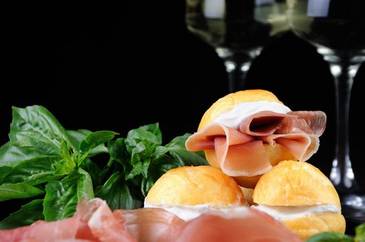 Coccoli is an appetizer from Italy. Pizza dough balls are fried and sprinkled with salt, served with prosciutto and cheese. Traditional Food During Christmas Period.They are also called pittule o pettole,I Coccoli toscani,Coccoli Fiorentini .