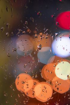 Water drops on window with color background