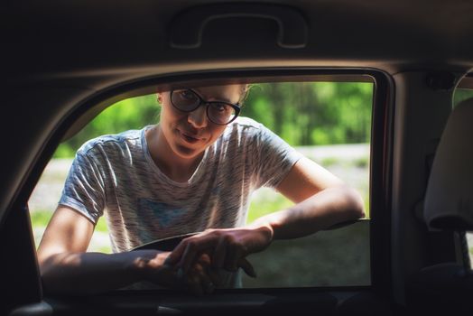 Travel, car and real life concept - woman looking from car window, outdoor