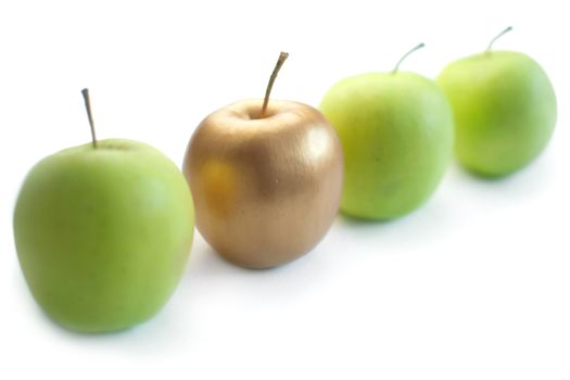 Gold apple standing out in a line of green