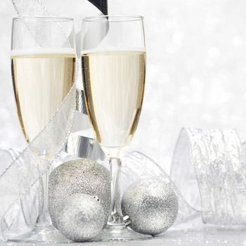 Champagne and new year decor on silver bokeh background