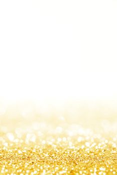 Abstract shining glitters gold holiday bokeh background with white copy space