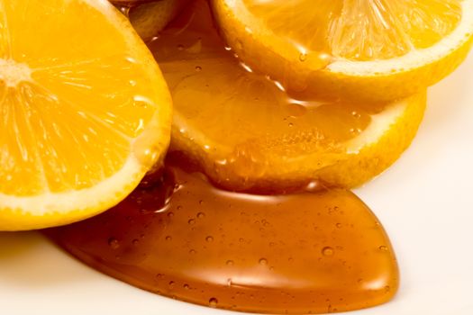 Closeup of sliced lemon and wooden spoon with honey