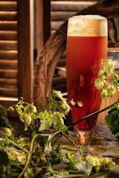 Glass of brown ale on an old wooden desk
