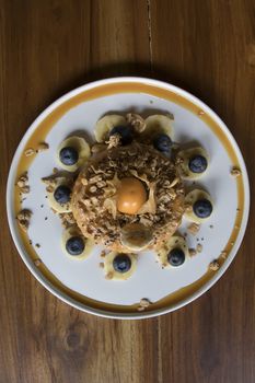 Overhead Shot Donut Cake with Granola on Wooden Table Flat Lay