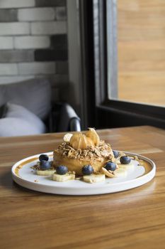 Close Up Shot Donut Cake with Granola Banana and Berry on top with Orange