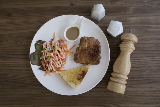 Chicken Steak with salad flat lay on wood table