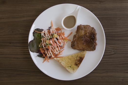 Chicken Steak with salad overhead shot on wooden table