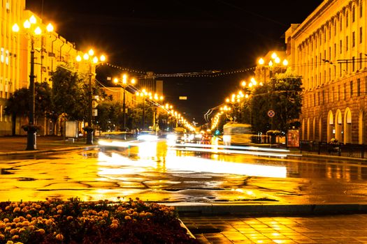 Night city landscape. The main square of the city of Khabarovsk in the light of lanterns, which are reflected in puddles after the rain just passed.