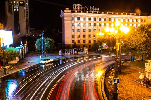 Night city landscape. The main square of the city of Khabarovsk in the light of lanterns, which are reflected in puddles after the rain just passed.