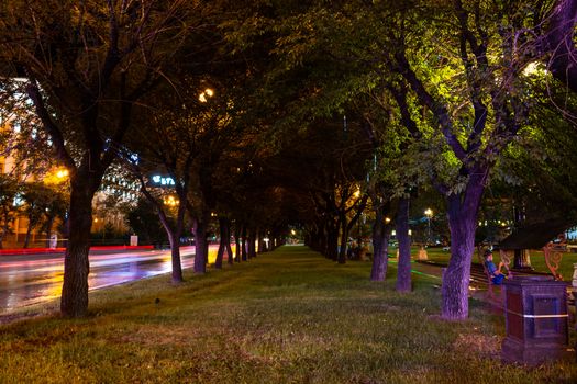 Night city landscape. The main square of the city of Khabarovsk in the light of lanterns, which are reflected in puddles after the rain just passed.