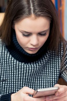 Portrait of a beautiful girl with a phone close-up