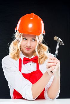 Crazy cook in helmet with a hammer on a black background