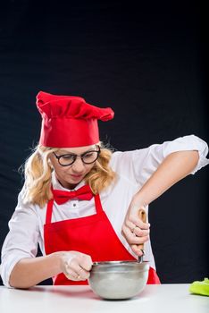 The girl animator in the chef's suit conducts experiments on the preparation of ice cream